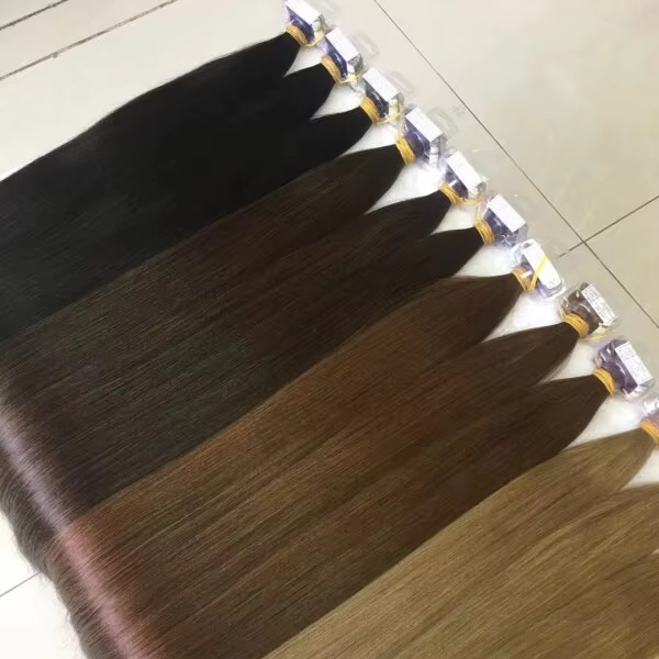 Wholesale human hair extensions in multiple colors, Remy hair wefts for salons and hair extension suppliers, featuring natural black, brown, and balayage shades.